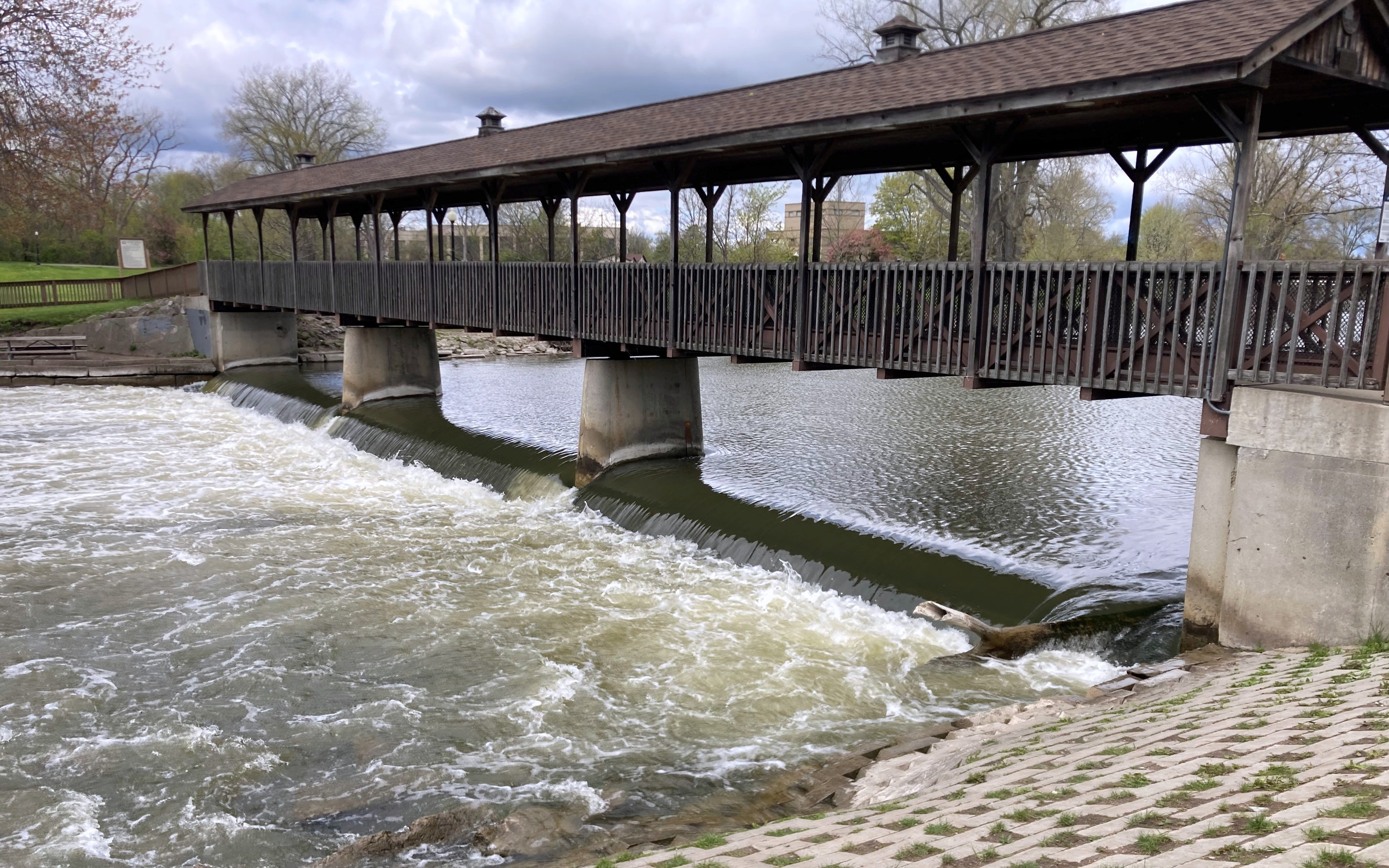 : Photos of two dams that cross large rivers, with transportation structures over the top of each dam.